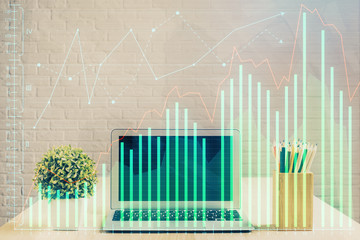 Double exposure of graph and financial info and work space with computer background. Concept of international online trading.
