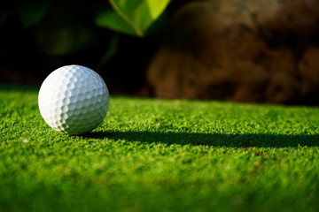 Golf ball on green grass in beautiful golf course