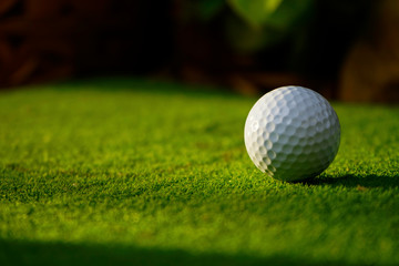 Golf ball on green grass in beautiful golf course