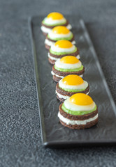 Canape with fried quail eggs