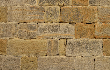 Sandstone brick wall texture with joint. Beige color.