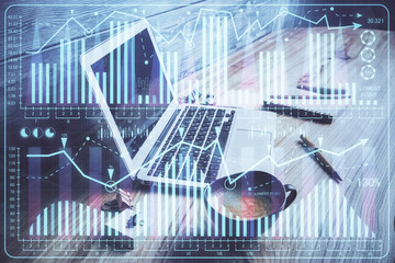 Multi exposure of graph and financial info and work space with computer background. Concept of international online trading.