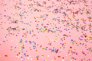 Fototapeta premium Festive background with colored star confetti. Abstract backdrop for Christmas New Year birthday party