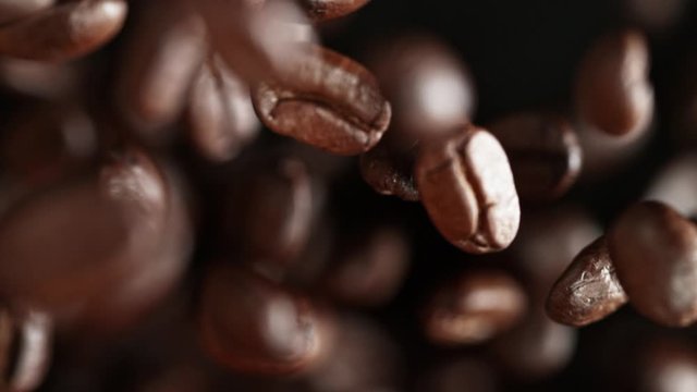 Super Slow Motion Shot of Exploding Premium Coffee Beans Towards the Camera at 1000fps.