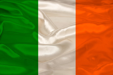 beautiful photo of the colored national flag of the modern state of Ireland on textured fabric, concept of tourism, emigration, economics and politics, closeup
