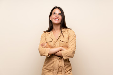 Young girl over isolated background looking up while smiling