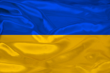 beautiful photo of the colored national flag of the modern state of Ukraine on textured fabric, concept of tourism, emigration, economics and politics, closeup