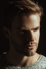 Muscle strong beautiful stripped male model with black t-shirt in denim blue jeans on black isolated font background