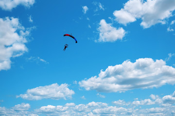 Skydiver with a black red blue canopy