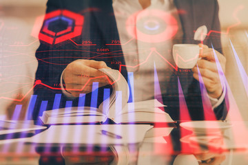 Double exposure of businessman with coffee with stock market forex chart.