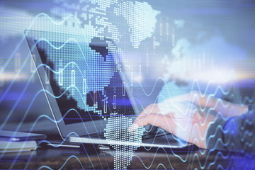 Double exposure of man's hands writing notes with laptop of stock market with forex graph background. Top View. Concept of research and trading.