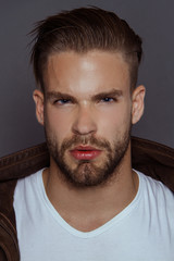 Fototapeta premium Muscle strong beautiful stripped male model with casual cloathes ongrayisolated font background