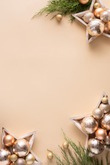 Happy new year gold baubles branches on beige background, vertical