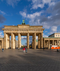 The Brandenburg Gate in Berlin, Germany, against a beautiful blue sky with some clouds