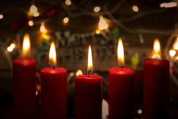 Obraz na płótnie Canvas Close up of candles with blurred Christmas light