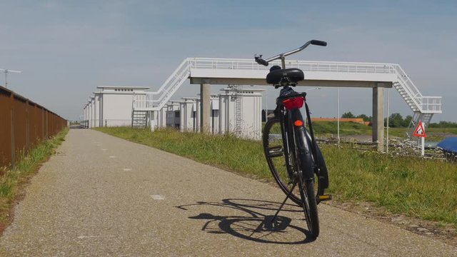 One pushbike standing by itself without a rider on a bike track.