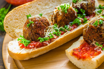 healthy sub  sandwiches with vegan lentil  meatballs tomato sauce grated cheese parsley close up
