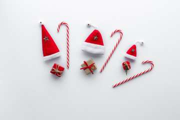 Christmas composition. Santa hat candy cane gift star top view background with copy space for your text. Flat lay.