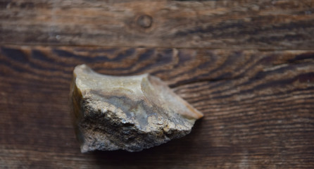 stone flint on a wooden Board