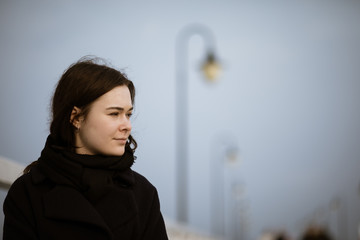 Portrait of young woman walking on pier