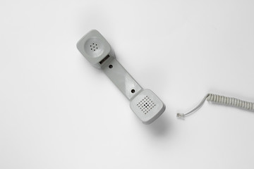 Reto handset phone with cable on white background. Call center. Hotline. Top view