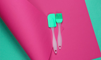 Kitchen tools on wrapped paper background. Minimalistic cooking still life. Pastel color trend