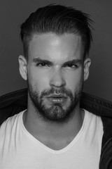 Black and White Muscle strong beautiful stripped male model in casual cloath on black isolated font background