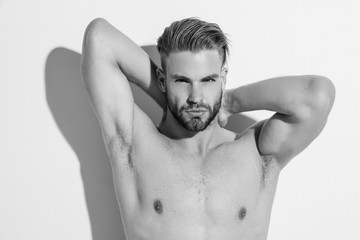 Fototapeta premium Black and White Muscle strong beautiful stripped male model in denim jeans on white isolated font background with shadows