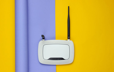 Wi-fi router on wrapped paper background. Pastel color trend, minimalistic still life. Modern...