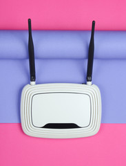 Wi-fi router on wrapped paper background. Pastel color trend, minimalistic still life. Modern...