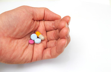 Hand holded medical pills before  oral take in medical healthcare consumption concept with copy space