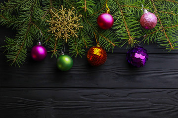 Beautiful Christmas toys with fir tree twigs on wooden background. With space for text