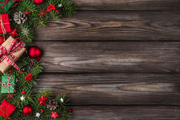 Christmas or Happy New Year flat lay background. fir branches, decorations, gift boxes and pine cones on rustic table