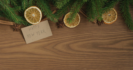 Top view border background with spruce branches, happy new year card and natural decorations