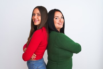 Young beautiful women wearing casual clothes standing over isolated white background happy face smiling with crossed arms looking at the camera. Positive person.