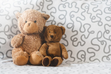 Two teddy bear plush toy on a sofa. Concept of love and togetherness