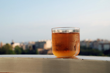 A glass of lager on a ledge above the Turia river park in Valencia, Spain