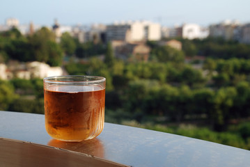 A glass of lager on a ledge above the Turia river park in Valencia, Spain