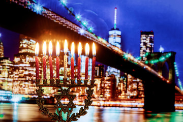 Jewish holiday hannukah symbols menorah, wide view Brooklyn Bridge New York