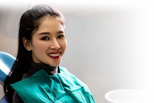 Dentist examining mouth teeth of beautiful young Asian woman in hospital clinic dental health care beautify oral hygiene concept