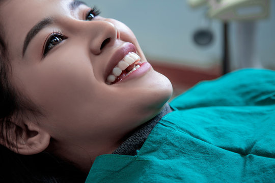 Dentist examining mouth teeth of beautiful young Asian woman in hospital clinic dental health care beautify oral hygiene concept