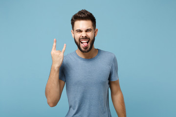 Young funny man in casual clothes posing isolated on blue background, studio portrait. People...