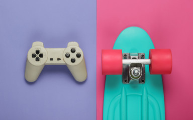 The concept of childhood, entertainment. Cruiser board, gamepad on colored background. Summer fun....