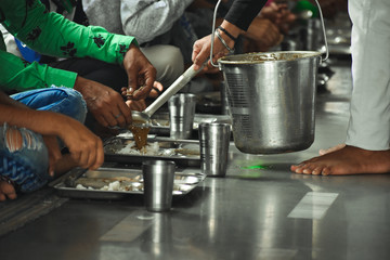 Without discriminating against race and color, people are sitting down together eating food called...