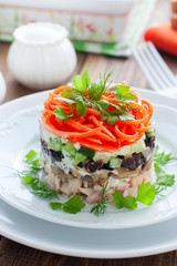 Salad with mushrooms, prunes, Korean carrots on a white plate, selective focus