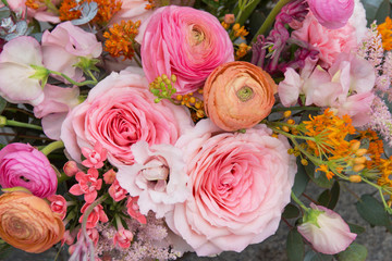 Beautiful elegant wedding pink orange bouquet with roses flowers close up. Floral background