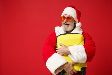 Laughing elderly gray-haired mustache bearded Santa man in Christmas hat, sunglasses posing...