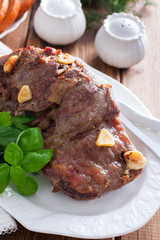Baked beef filet whole piece on a wooden table, selective focus