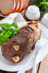 Baked beef filet whole piece on a wooden table, selective focus