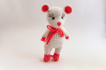 Gray mouse Amigurumi posing for a photographer standing on a white background.